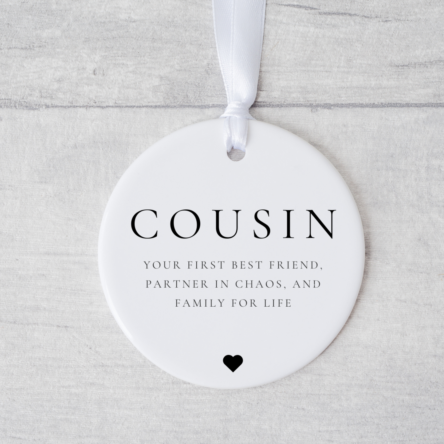 A ceramic heart-shaped cousin gift coaster with a sentimental quote, a thoughtful keepsake to celebrate the bond between cousins