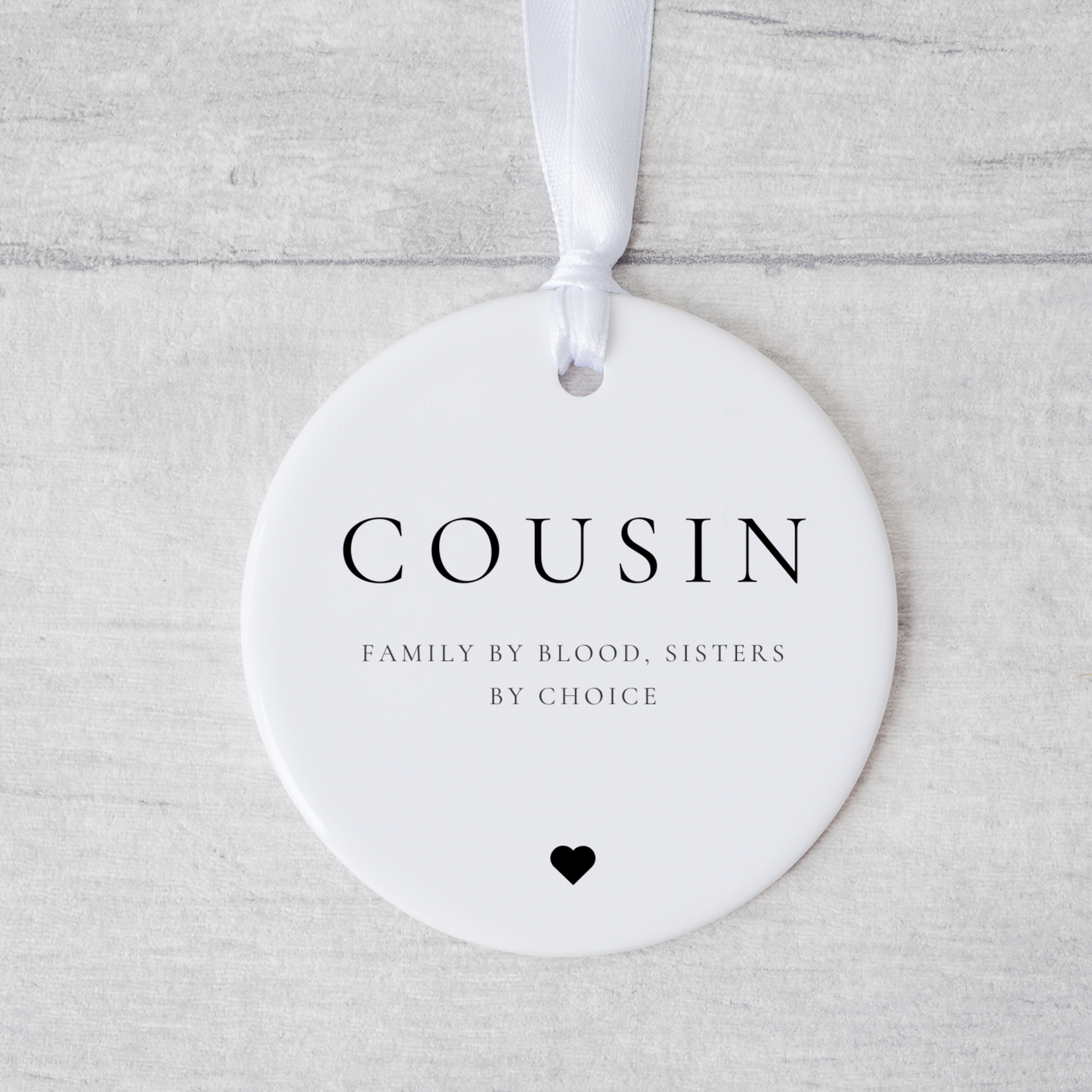 A ceramic heart-shaped cousin gift coaster with a sentimental quote, a thoughtful keepsake to celebrate the bond between cousins