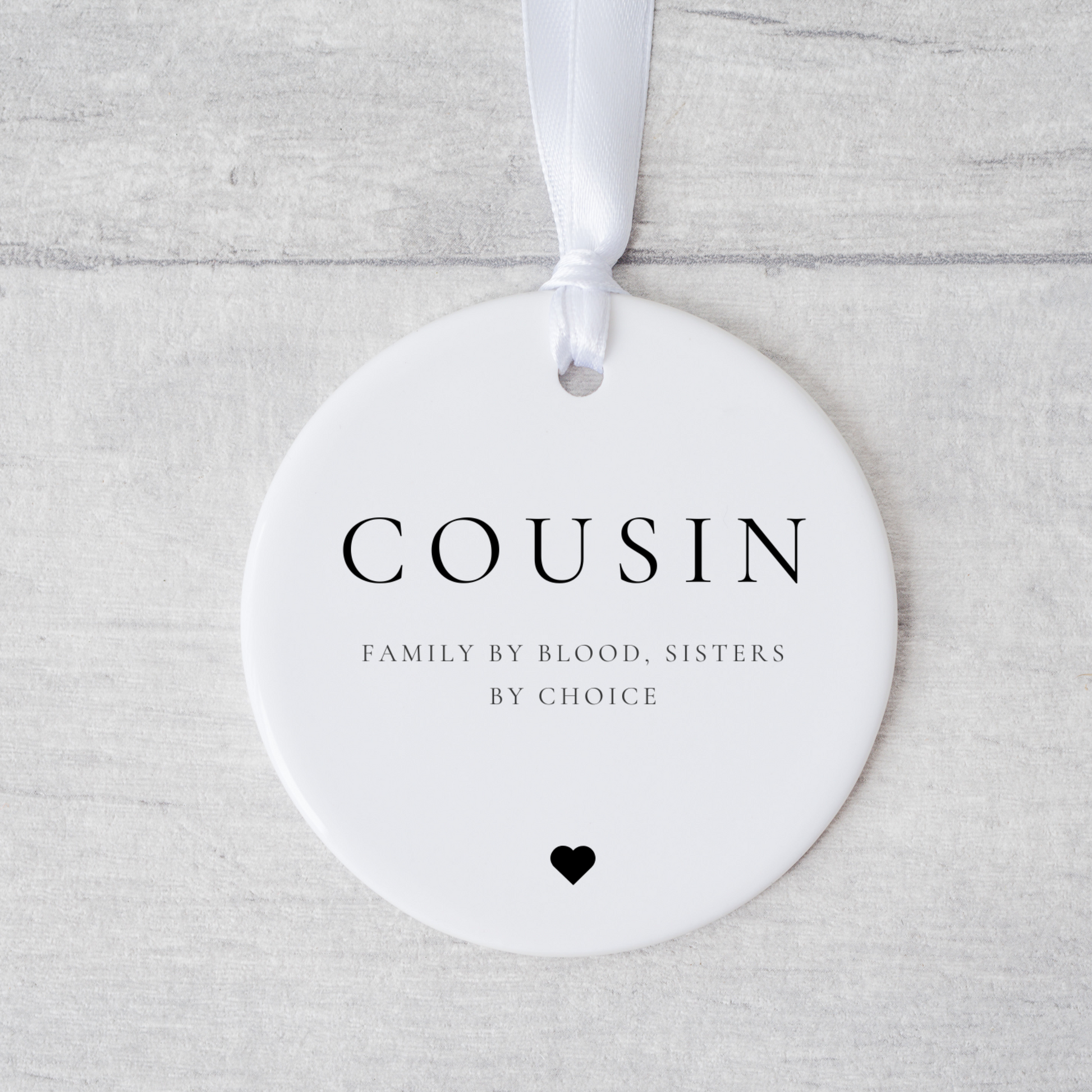 A ceramic heart-shaped cousin gift coaster with a sentimental quote, a thoughtful keepsake to celebrate the bond between cousins