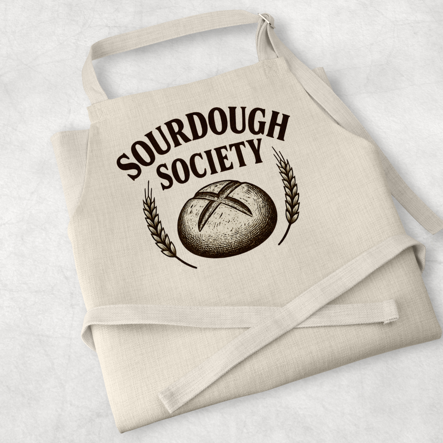 White cotton cooking apron with a playful sourdough-themed design, perfect for baking lovers, mums, and sourdough enthusiasts