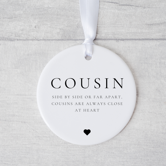 A ceramic heart-shaped cousin gift coaster with a sentimental quote, a thoughtful keepsake to celebrate the bond between cousins