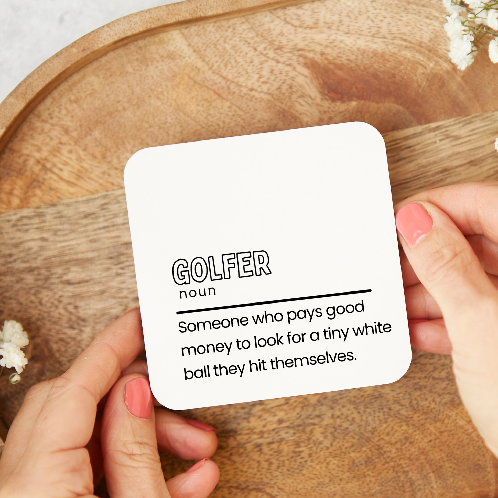 Funny Golfer definition coaster saying someone who pays good money to look for a tiny white ball they hit themselves