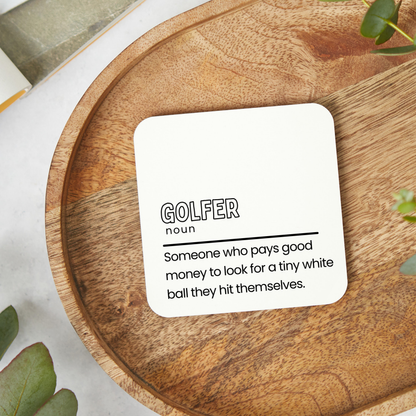 Funny Golfer definition coaster saying someone who pays good money to look for a tiny white ball they hit themselves