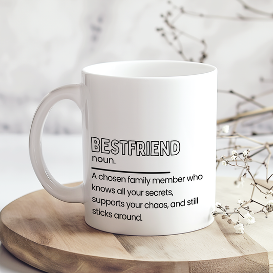 White ceramic mug with “Bestfriend noun.” definition style quote in black typography, featuring a heartfelt and funny description about friendship and support, displayed on a neutral wooden background.