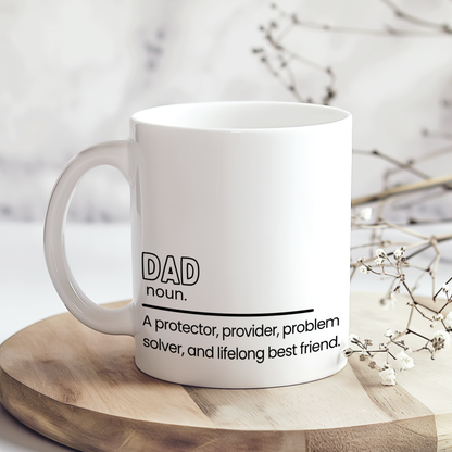 White ceramic mug with heartfelt dad definition quote reading “A protector, provider, problem solver, and lifelong best friend,” displayed on wooden board in neutral styled mockup, sentimental Father’s Day gift for dads.