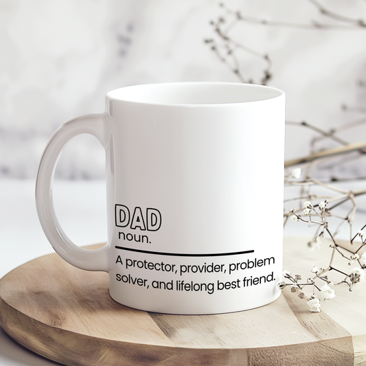 White ceramic mug with heartfelt dad definition quote reading “A protector, provider, problem solver, and lifelong best friend,” displayed on wooden board in neutral styled mockup, sentimental Father’s Day gift for dads.