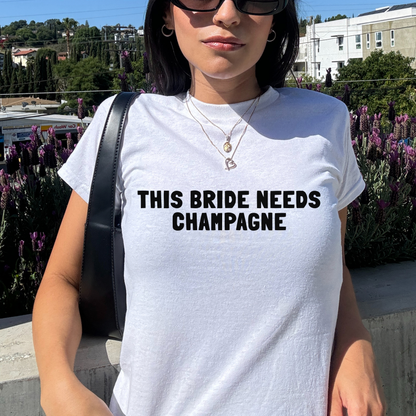 This Bride Needs Champagne Baby Tee | Hen Do Bride Outfit | Bridal Shower Gift | Bachelorette Party Top