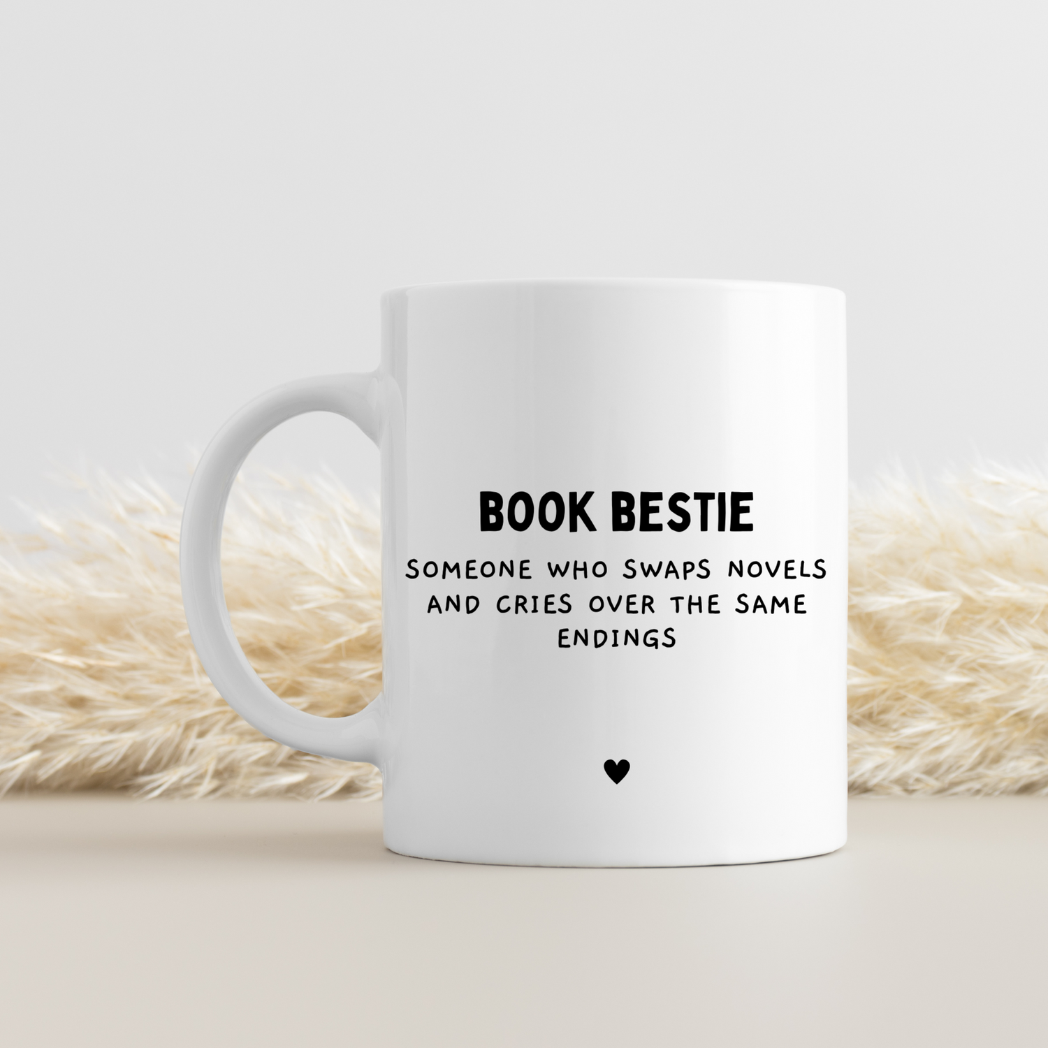 White ceramic mug with 'Book Bestie Definition' design. Keepsake friendship gift for book lovers and reading enthusiasts. Glossy finish, dishwasher and microwave safe