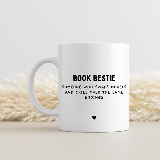 White ceramic mug with 'Book Bestie Definition' design. Keepsake friendship gift for book lovers and reading enthusiasts. Glossy finish, dishwasher and microwave safe