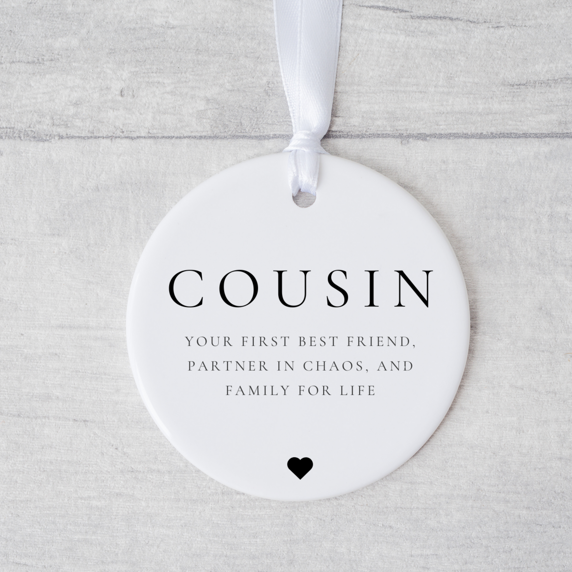 A ceramic heart-shaped cousin gift coaster with a sentimental quote, a thoughtful keepsake to celebrate the bond between cousins