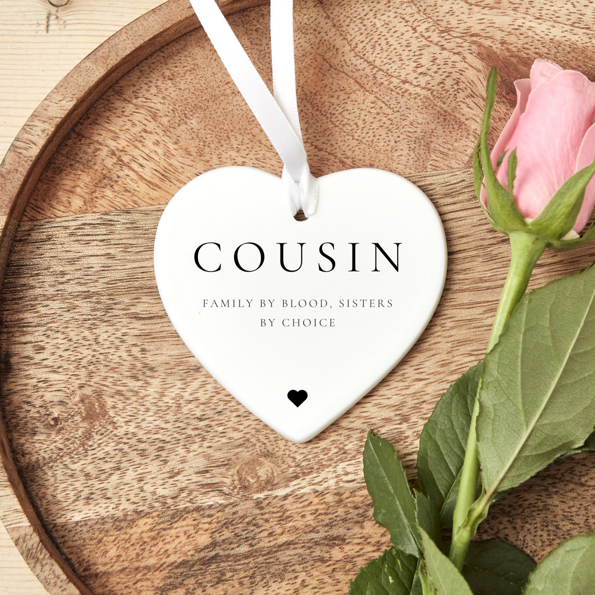 A ceramic heart-shaped cousin gift coaster with a sentimental quote, a thoughtful keepsake to celebrate the bond between cousins
