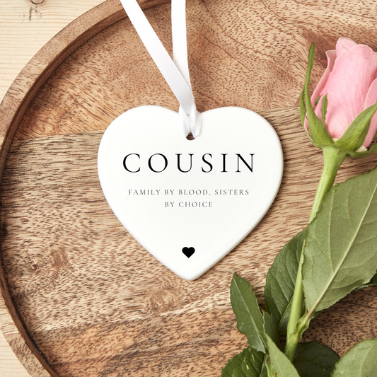 A ceramic heart-shaped cousin gift coaster with a sentimental quote, a thoughtful keepsake to celebrate the bond between cousins