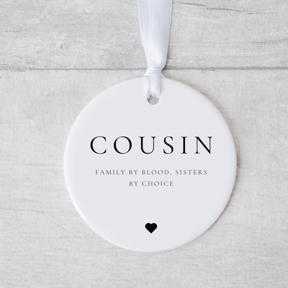 A ceramic heart-shaped cousin gift coaster with a sentimental quote, a thoughtful keepsake to celebrate the bond between cousins