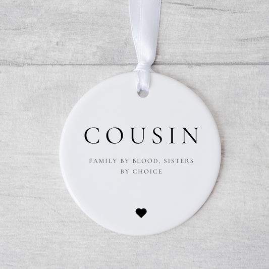 A ceramic heart-shaped cousin gift coaster with a sentimental quote, a thoughtful keepsake to celebrate the bond between cousins