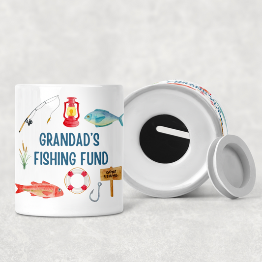 Personalised fishing money box with coin slot on top and rubber stopper at the bottom. Compact ceramic saving pot, 9.3cm tall by 8cm wide, ideal gift for fishing lovers and Father’s Day
