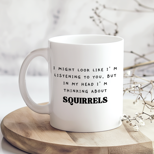 “White 11oz ceramic mug with a glossy finish featuring a funny squirrel design printed on both sides.”