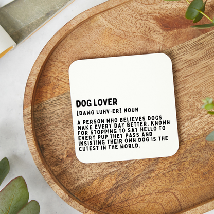 Funny dog lover coaster featuring a humorous dictionary style definition design in minimalist black typography on a glossy white 9x9cm coaster.