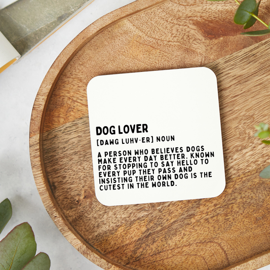 Funny dog lover coaster featuring a humorous dictionary style definition design in minimalist black typography on a glossy white 9x9cm coaster.