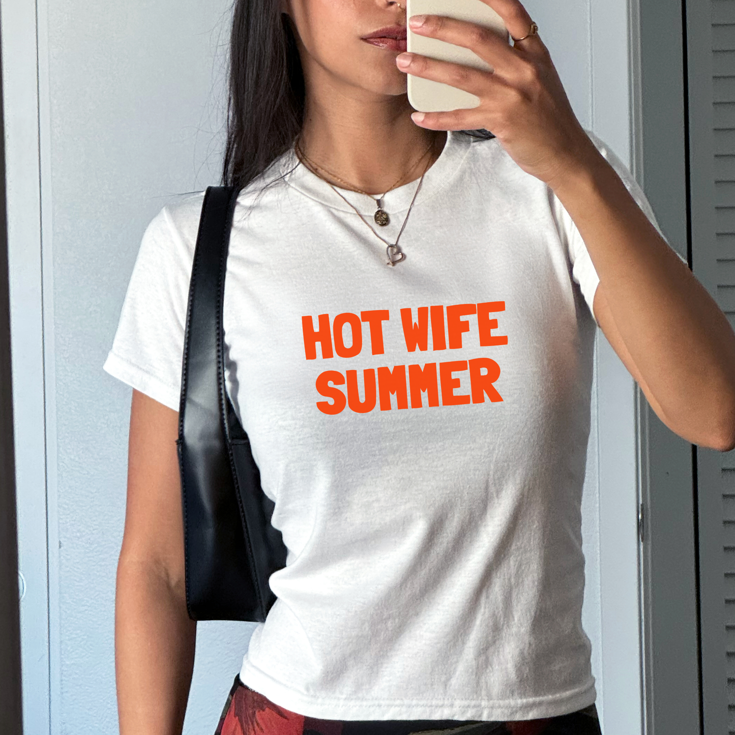 White fitted baby tee with “Hot Wife Summer” slogan in bold statement typography, styled as a hen party bride outfit.