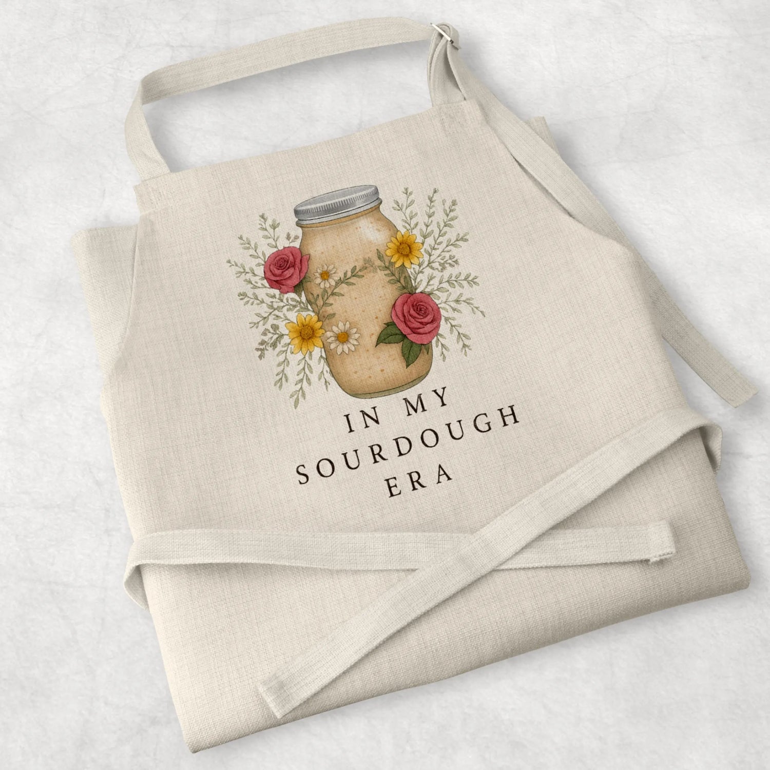 White cotton cooking apron with 'Sourdough Lover' design, perfect for baking enthusiasts and thoughtful mum gifts