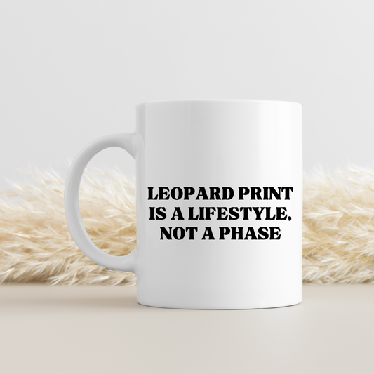 White ceramic mug with bold leopard print design. Fun gift for leopard print lovers, fashionistas, and trend-obsessed friends. Dishwasher and microwave safe