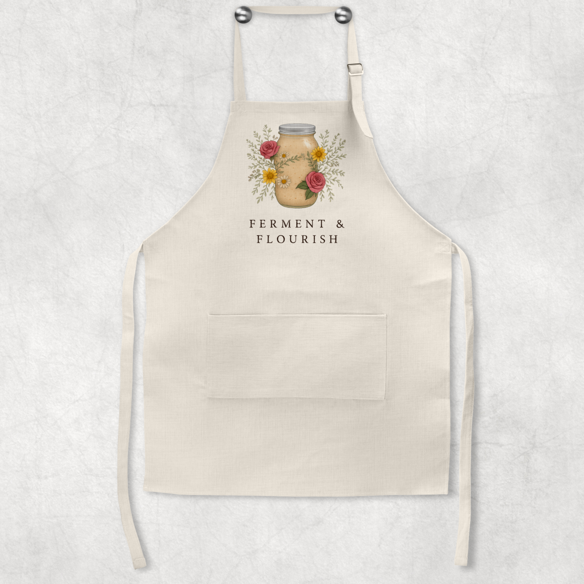Beige apron with floral design and text on a light gray background