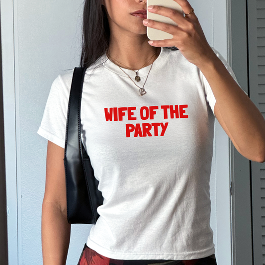 White fitted baby tee with “Wife of the Party” slogan in bold bridal typography, styled as a hen party outfit for the bride.