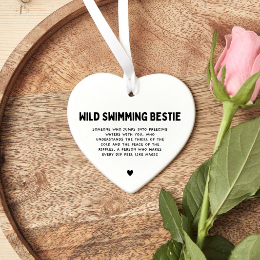Ceramic heart-shaped keepsake with the phrase ‘Wild Swimming Bestie’ in a decorative font. A thoughtful friendship gift for wild swimming lovers, suitable as a keepsake or token of appreciation