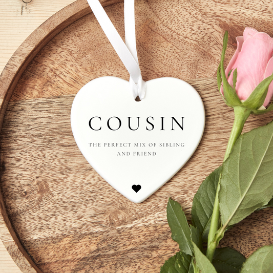 A ceramic heart-shaped cousin gift coaster with a sentimental quote, a thoughtful keepsake to celebrate the bond between cousins