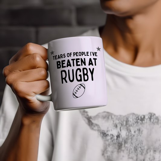 White glossy ceramic mug with a funny rugby-themed design — perfect humorous gift for rugby players and fans.