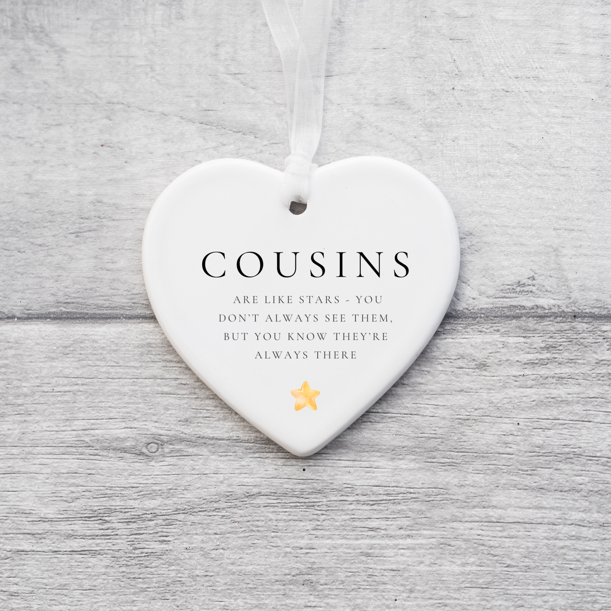 A ceramic heart-shaped cousin gift coaster with a sentimental quote, a thoughtful keepsake to celebrate the bond between cousins