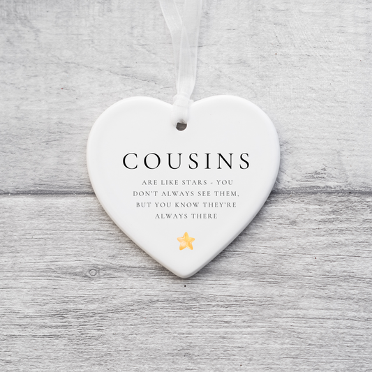 A ceramic heart-shaped cousin gift coaster with a sentimental quote, a thoughtful keepsake to celebrate the bond between cousins