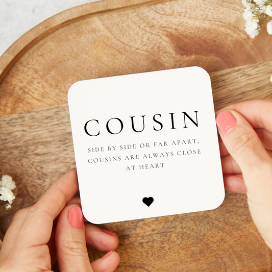 A ceramic heart-shaped cousin gift coaster with a sentimental quote, a thoughtful keepsake to celebrate the bond between cousins