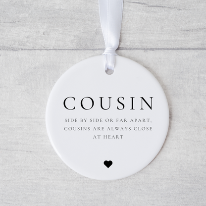 A ceramic heart-shaped cousin gift coaster with a sentimental quote, a thoughtful keepsake to celebrate the bond between cousins