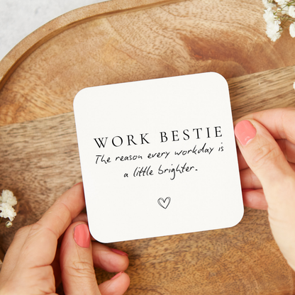 White ceramic heart Work Bestie hanging decoration with quote “The reason every workday is a little brighter” and white ribbon